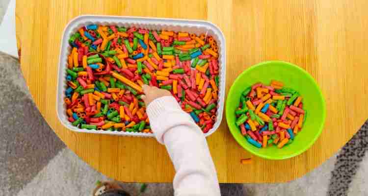 sensory play with coloured pasta