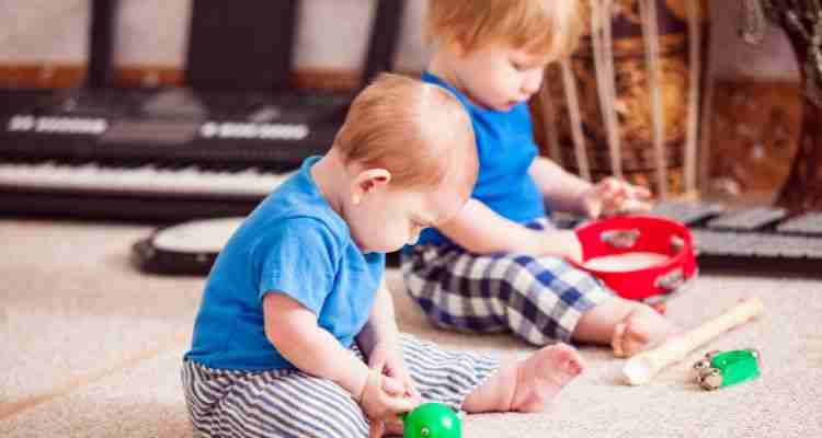 toddlers playing with musical toys