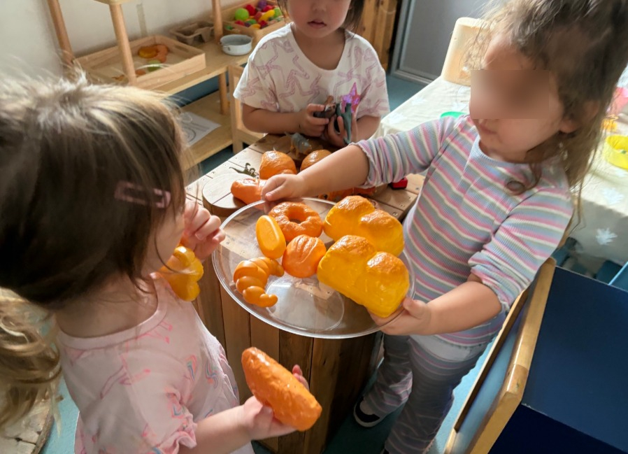 children learning through play with toy food items