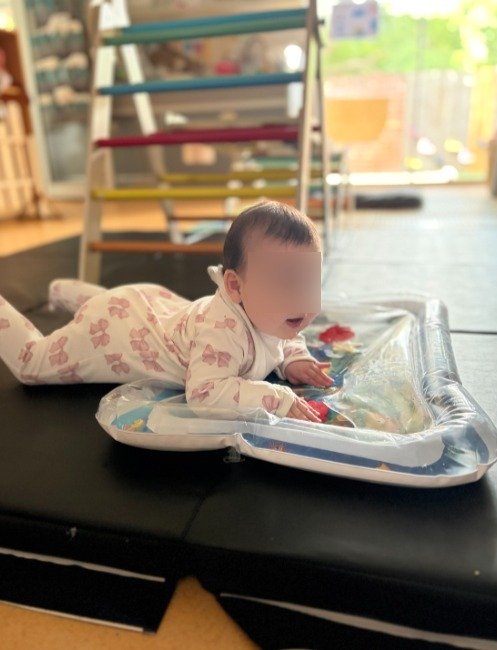 baby laying on her tummy on the sensory mat at kiddie garden